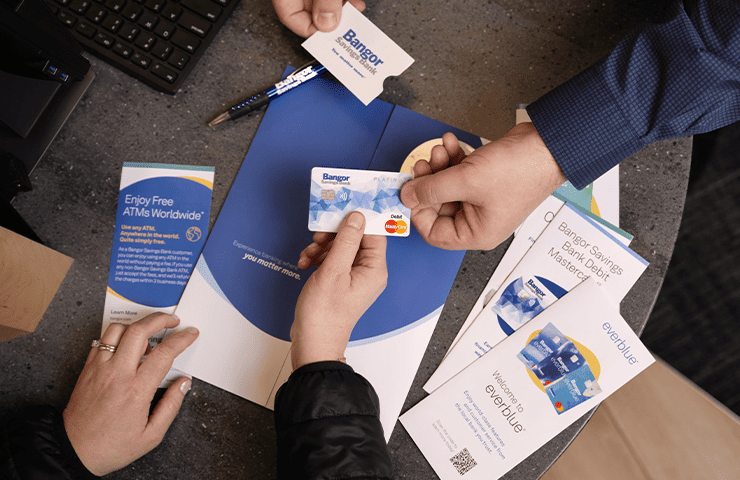 A customer opening an account with an employee with materials and a debit card