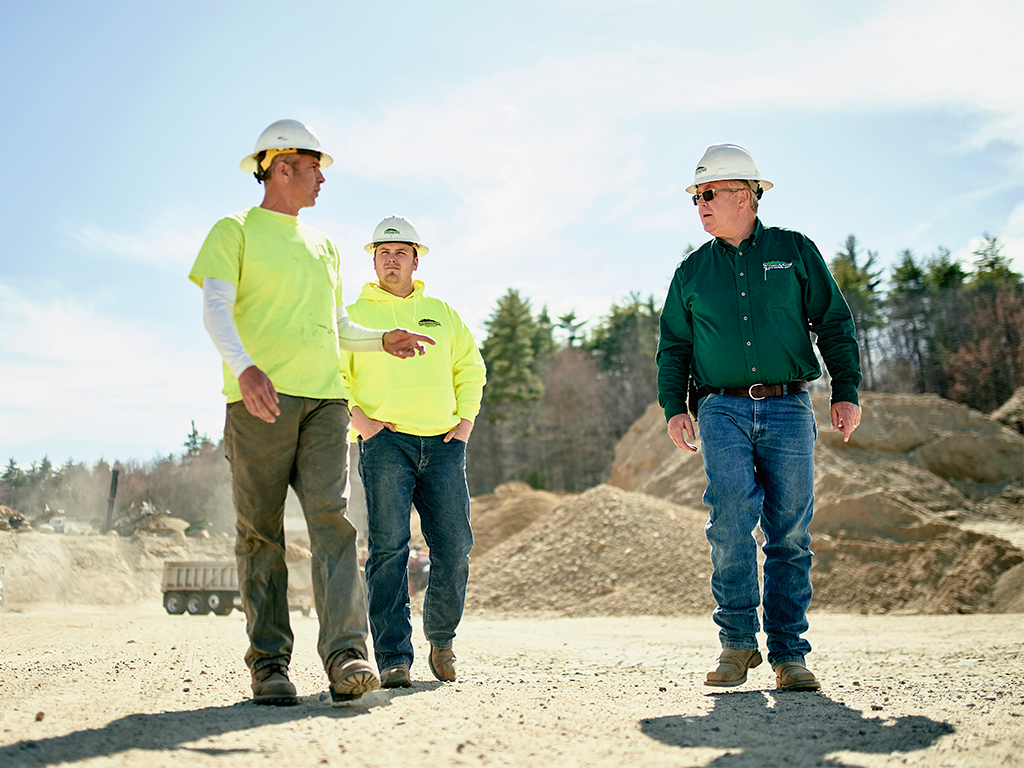 Men in construction helmets at a quarry