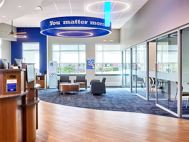 Interior of the Bangor Savings Bank branch on Brighton Avenue in Portland, Maine, showing modern teller pods and customer service area