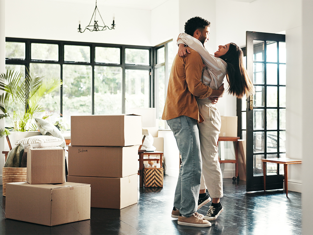 Man and woman hugging in their new home