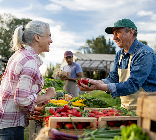 Woman making a purchase from a local farm stand