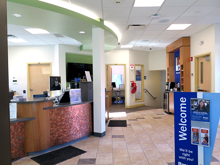 Interior of the Bangor Savings Bank branch at 77 Middle Street in Portland, Maine, featuring teller counter and customer service area